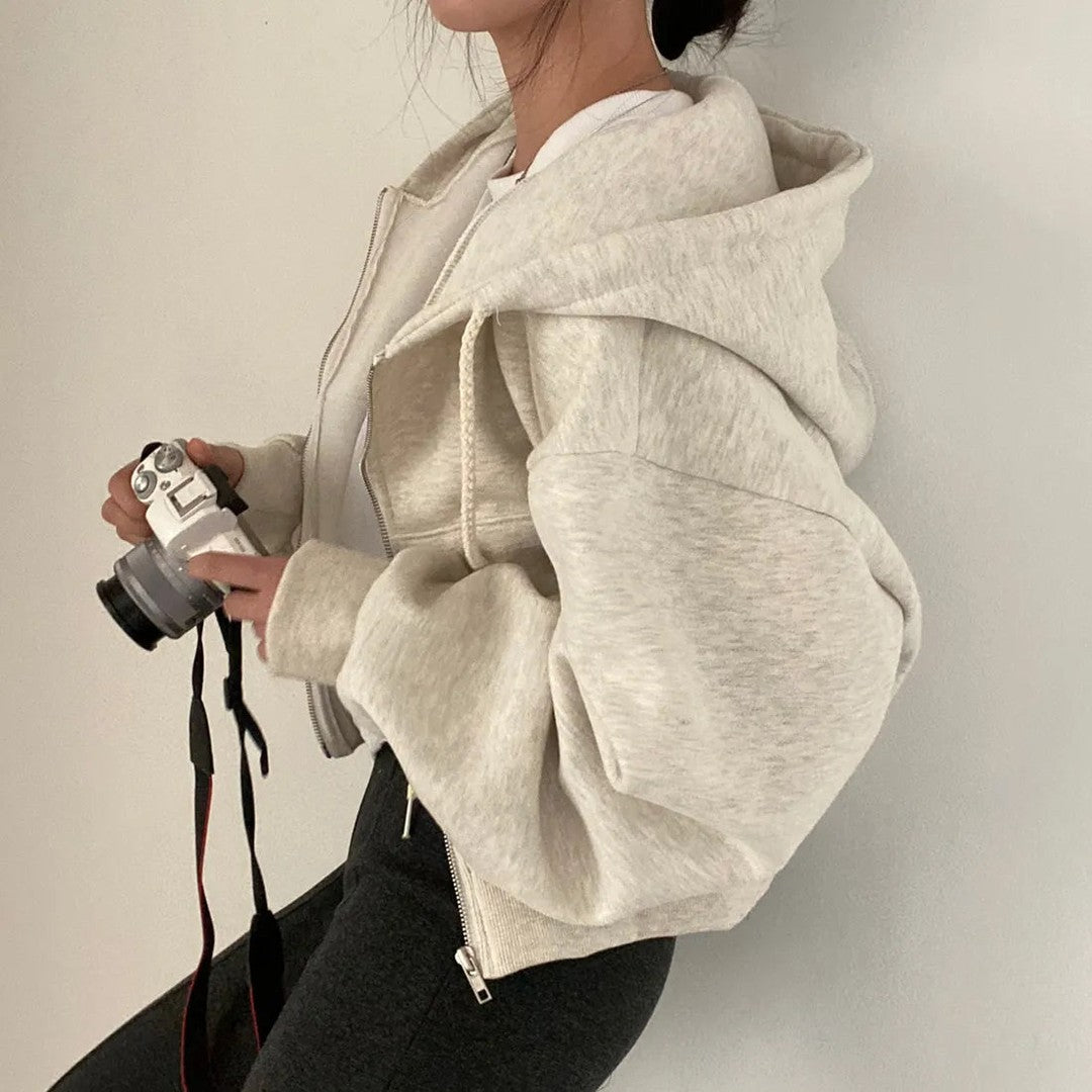 Woman wearing the Fiona women's zip-up sweatshirt, side view