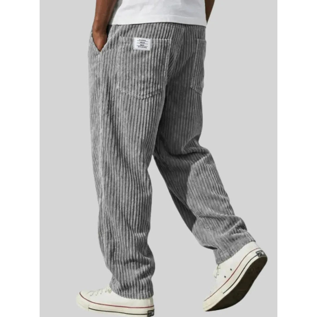 Man wearing the Sawyer men's relaxed corduroy drawstring pants, back view