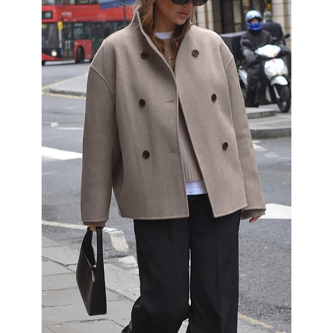 Woman wearing the Wilhelmina women's cropped mock-neck button-up jacket in beige, detail view