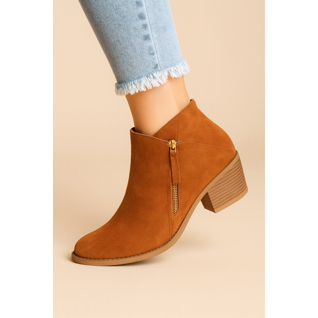 Woman wearing the Anais women's casual zip-up boots, flatlay view