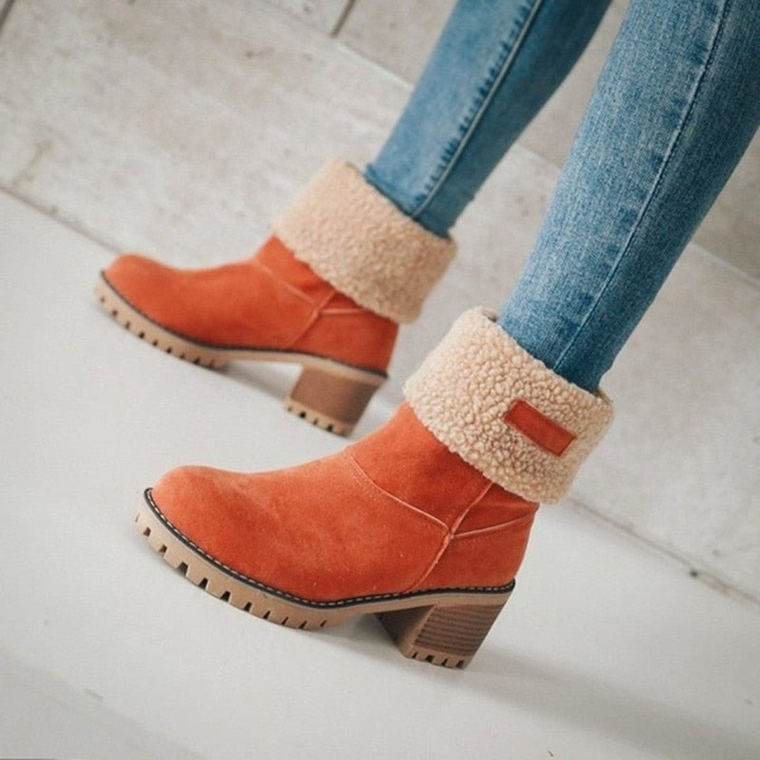 Woman wearing the Cleo women's boots in orange, side view