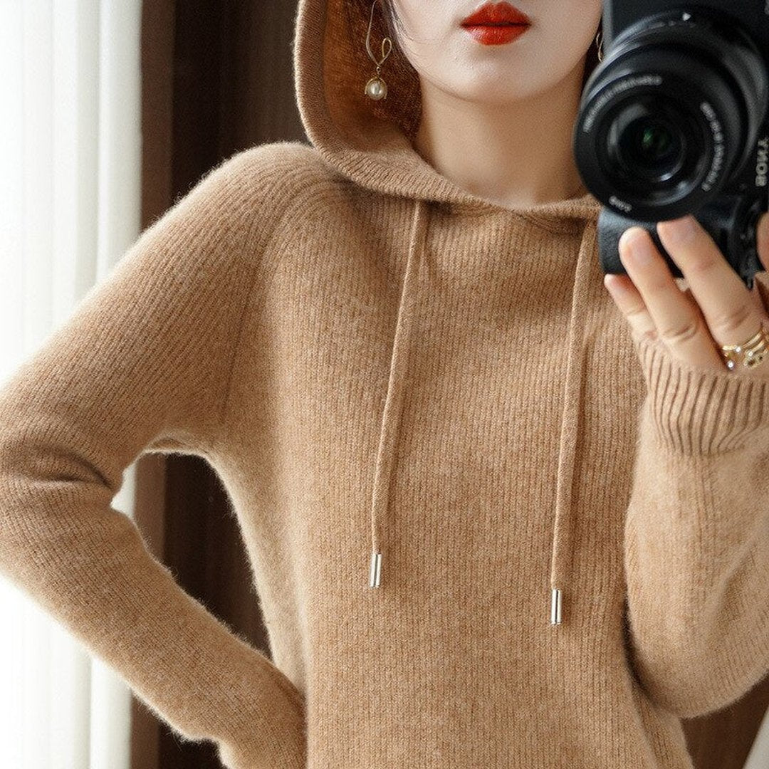 Woman wearing the Cora women's hooded cashmere hoodie, side view