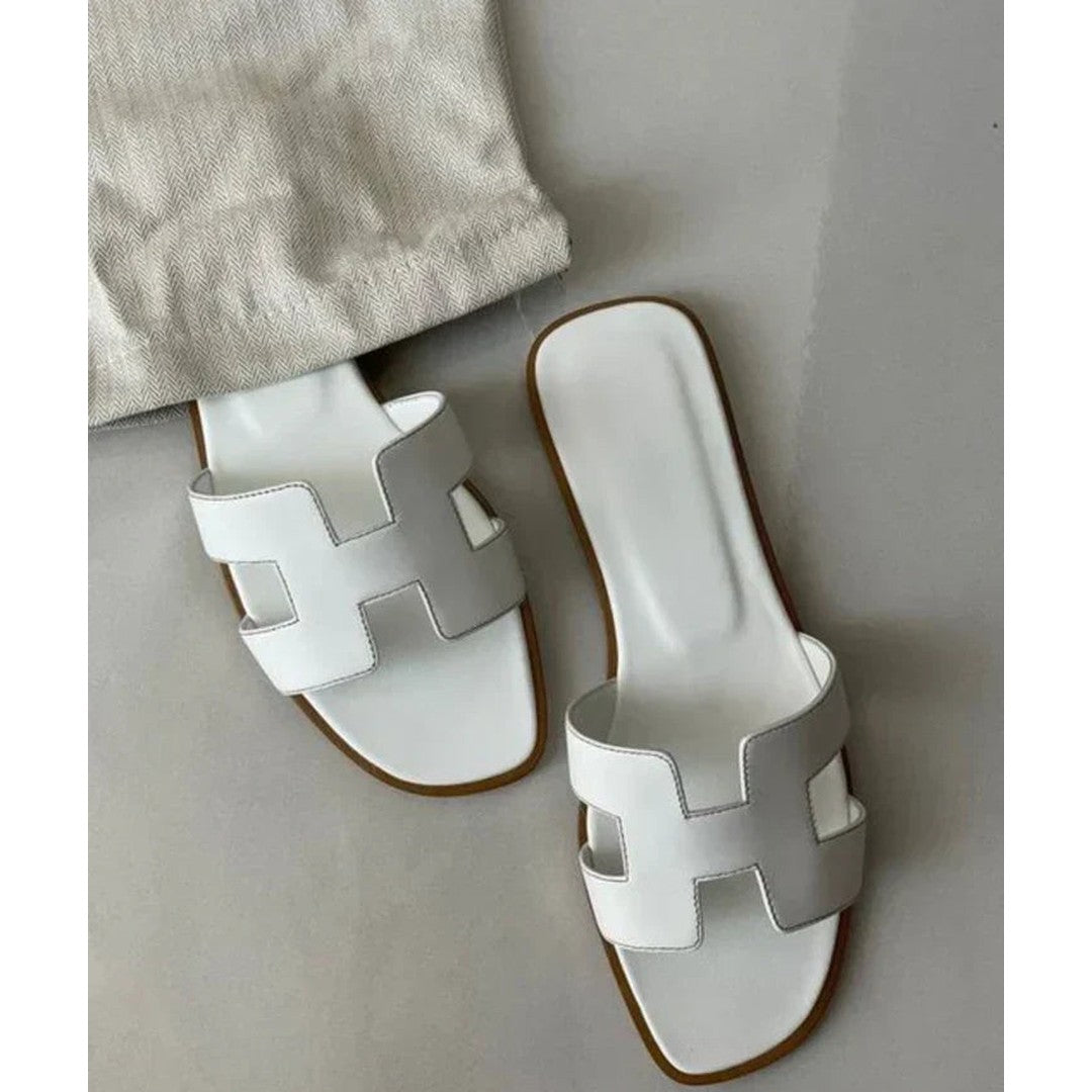Woman wearing the Dahlia women's leather sandals, back view