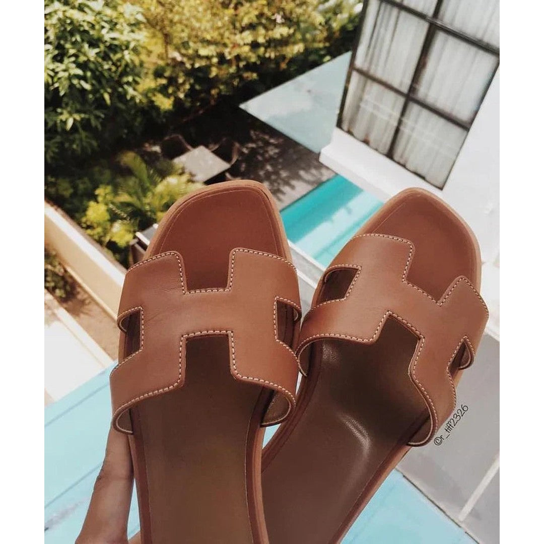 Woman wearing the Dahlia women's leather sandals, front view