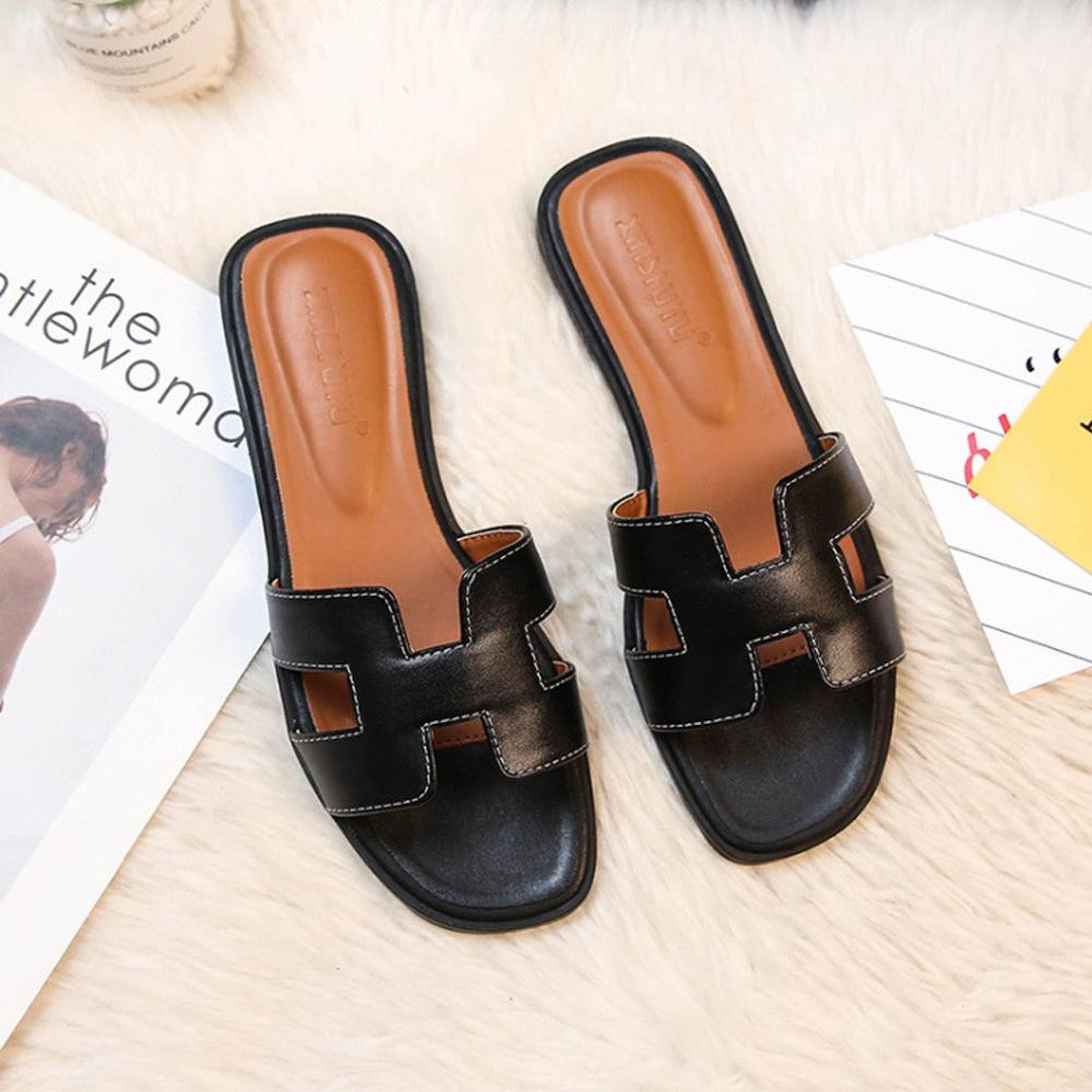 Woman wearing the Dahlia women's leather sandals, side view
