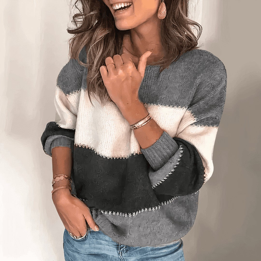 Woman wearing the Edda women's relaxed knit striped sweater, front view