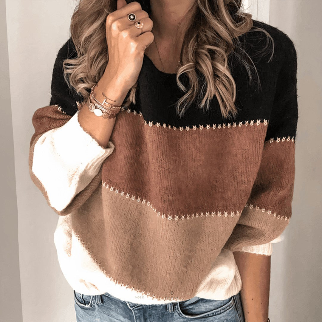 Woman wearing the Edda women's relaxed knit striped sweater, side view