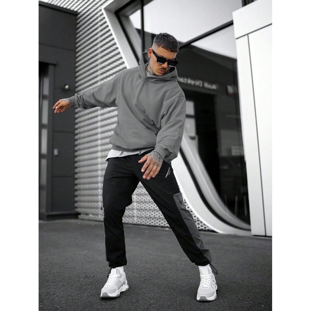 Man wearing the Florian men's solid-color cotton streetwear hoodie, side view
