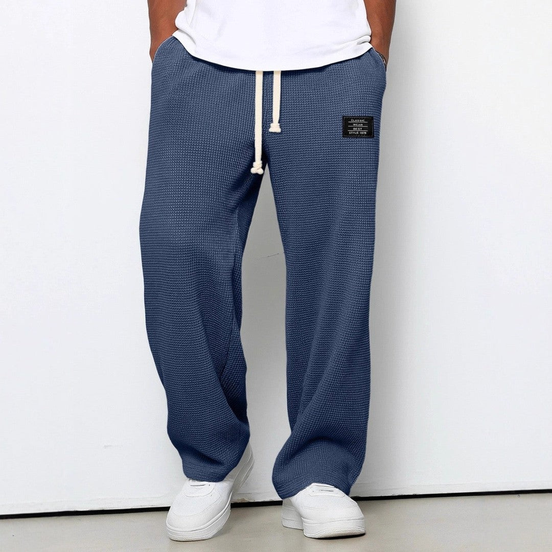 Man wearing the Gerard men's relaxed denim breathable pants, flatlay view