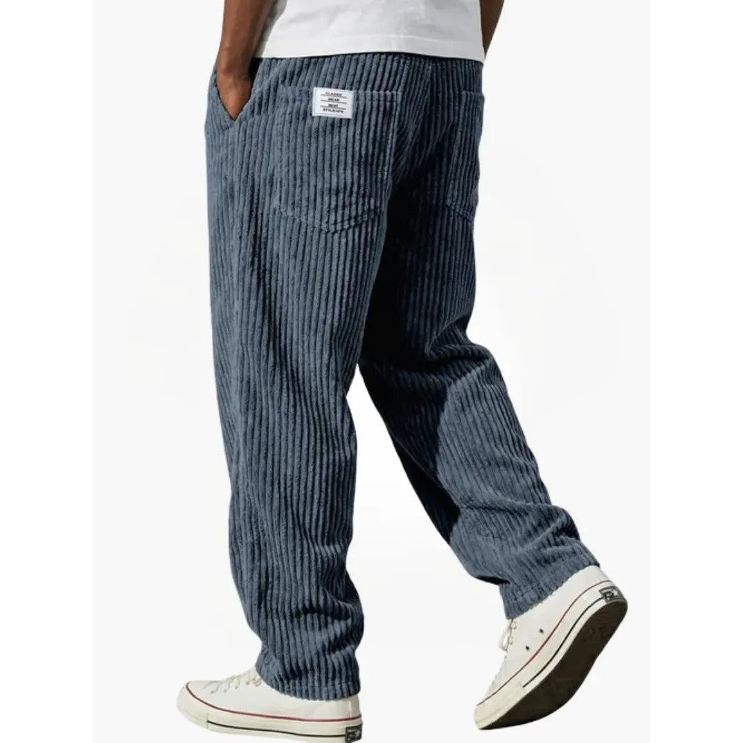 Man wearing the Sawyer men's relaxed corduroy drawstring pants, side view
