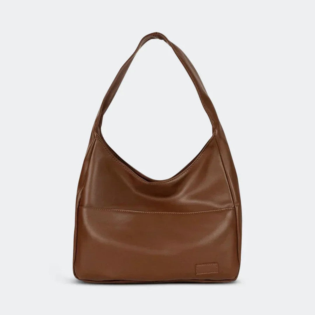 Woman wearing the Zosia women's pocket detail bag, front view