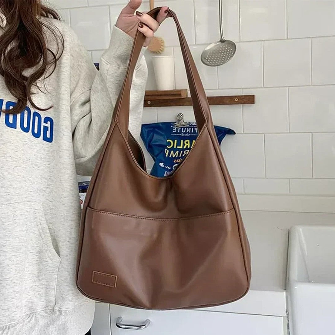 Woman wearing the Zosia women's pocket detail bag, side view
